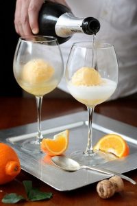 Pour champagne over orange sherbert